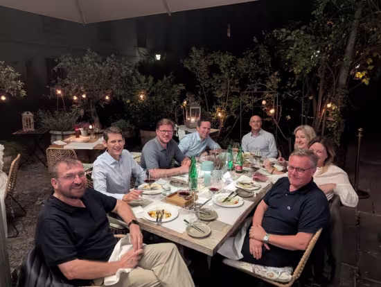 the members of the board sitting around a table with food