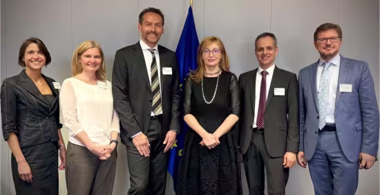 A group picture of the participants in front of EU flag