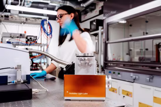 invisible light labs product picture inside of lab with woman working in the background