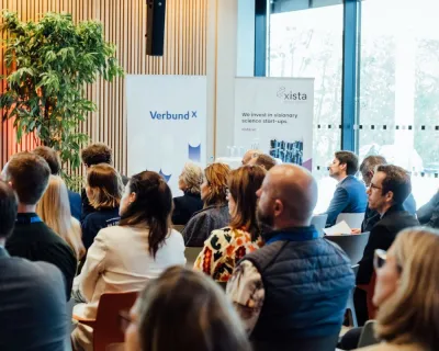 audience at venture day, roll-ups in the background