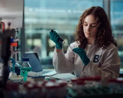 a scientist working in her lab currently pipetting something