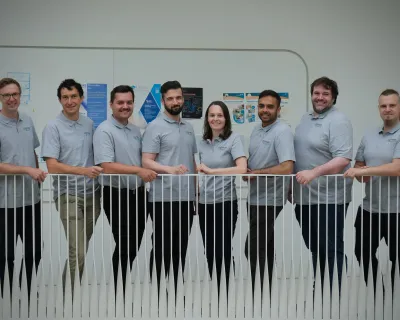 the collimatehealth team posing in front of banister wearing team shirts